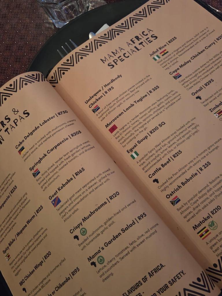 Mama Africa restaurant menu page featuring various specialty dishes, including Umlawa chicken, Moroccan Lamb Tagine, and Cape Malay chicken curry, with descriptions and prices.